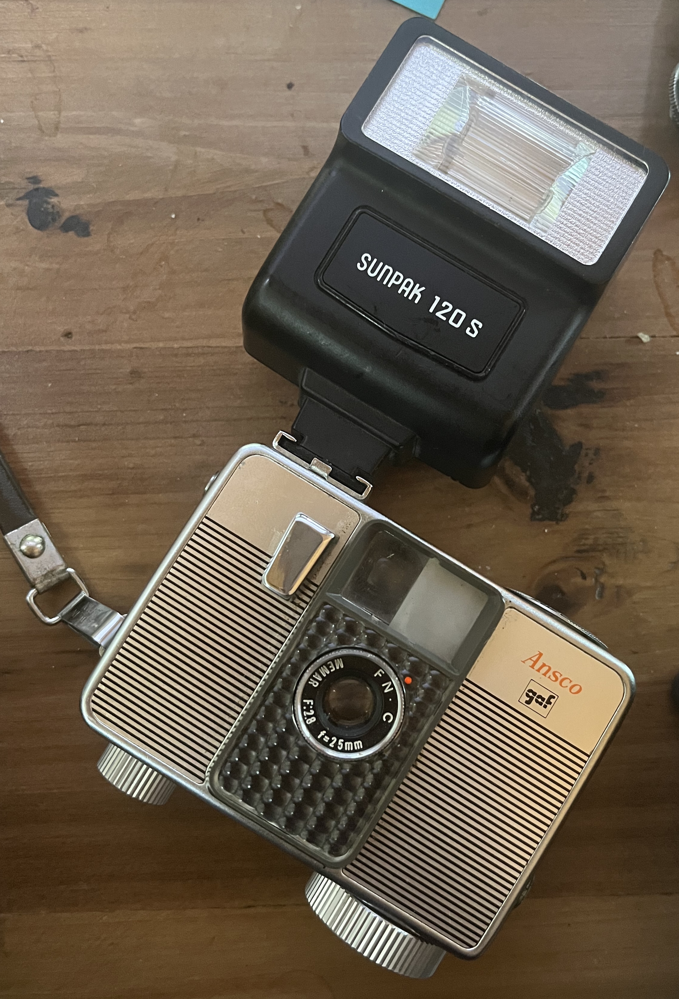 Photo of an ansco memo ii automatic half frame camera with a sunpak 120 flash installed